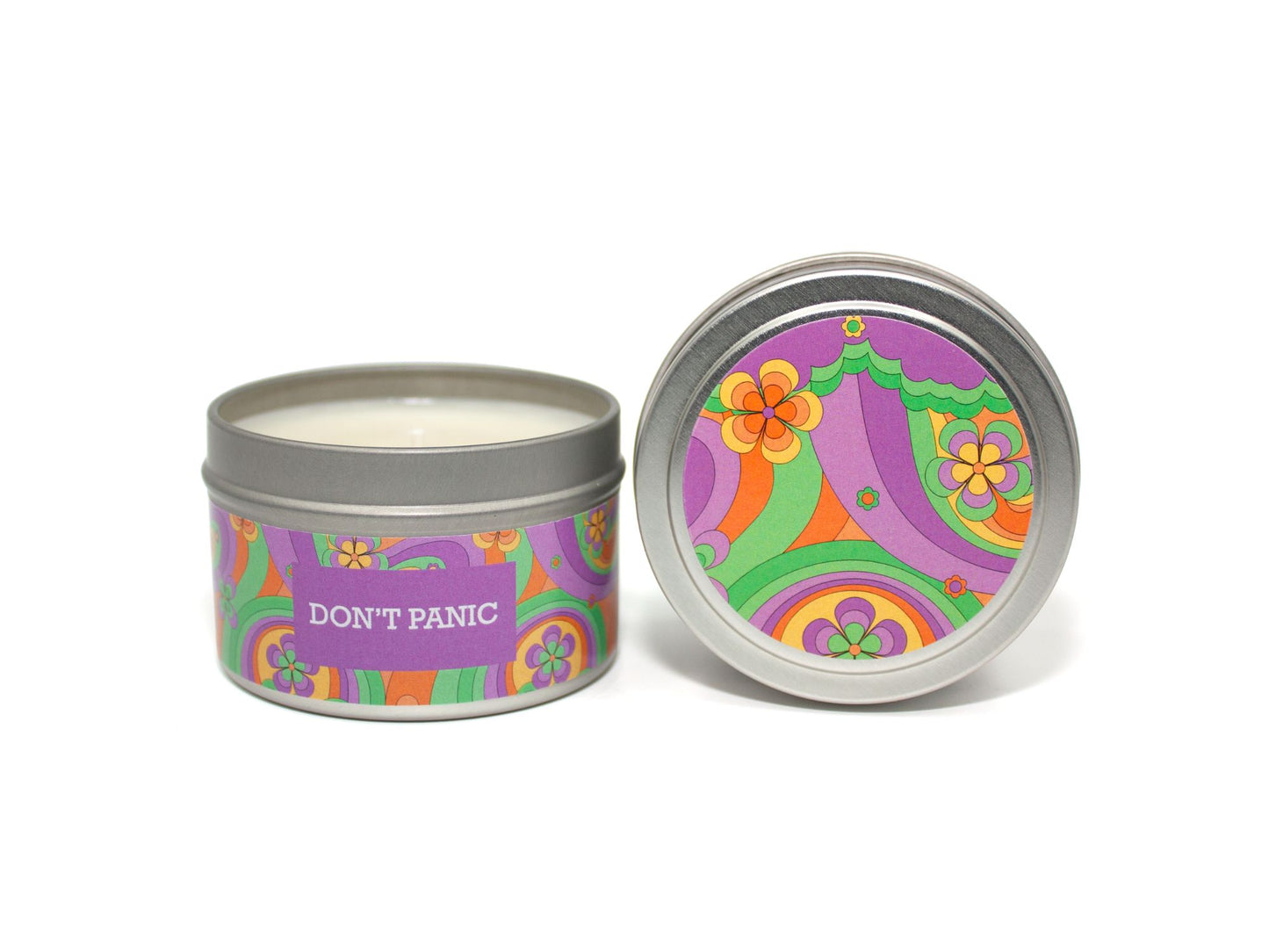 Onset & Rime relaxing lavendar scented candle called "Don't Panic" in a 4 oz silver tin. The circular label on top is a wavy psychedelic pattern with purple, green and orange flowers. The text on the front label is "Don't Panic - Lavender, Orange, Lime, Tonka Bean".