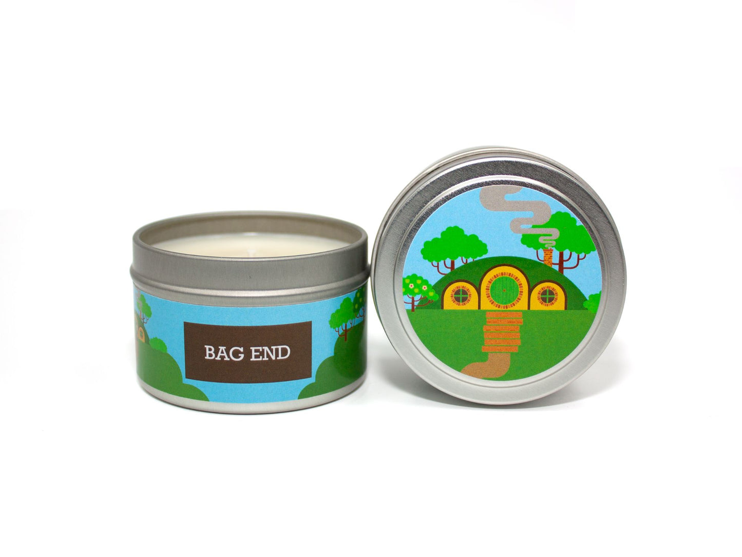 Onset & Rime apple tart scented candle called "Bag End" in a 4 oz silver tin. The circular label on top depicts Bilbo's cottage. The text on the front label is "Bag End - Baked Apple, Cinnamon, Brown Sugar Streusel".