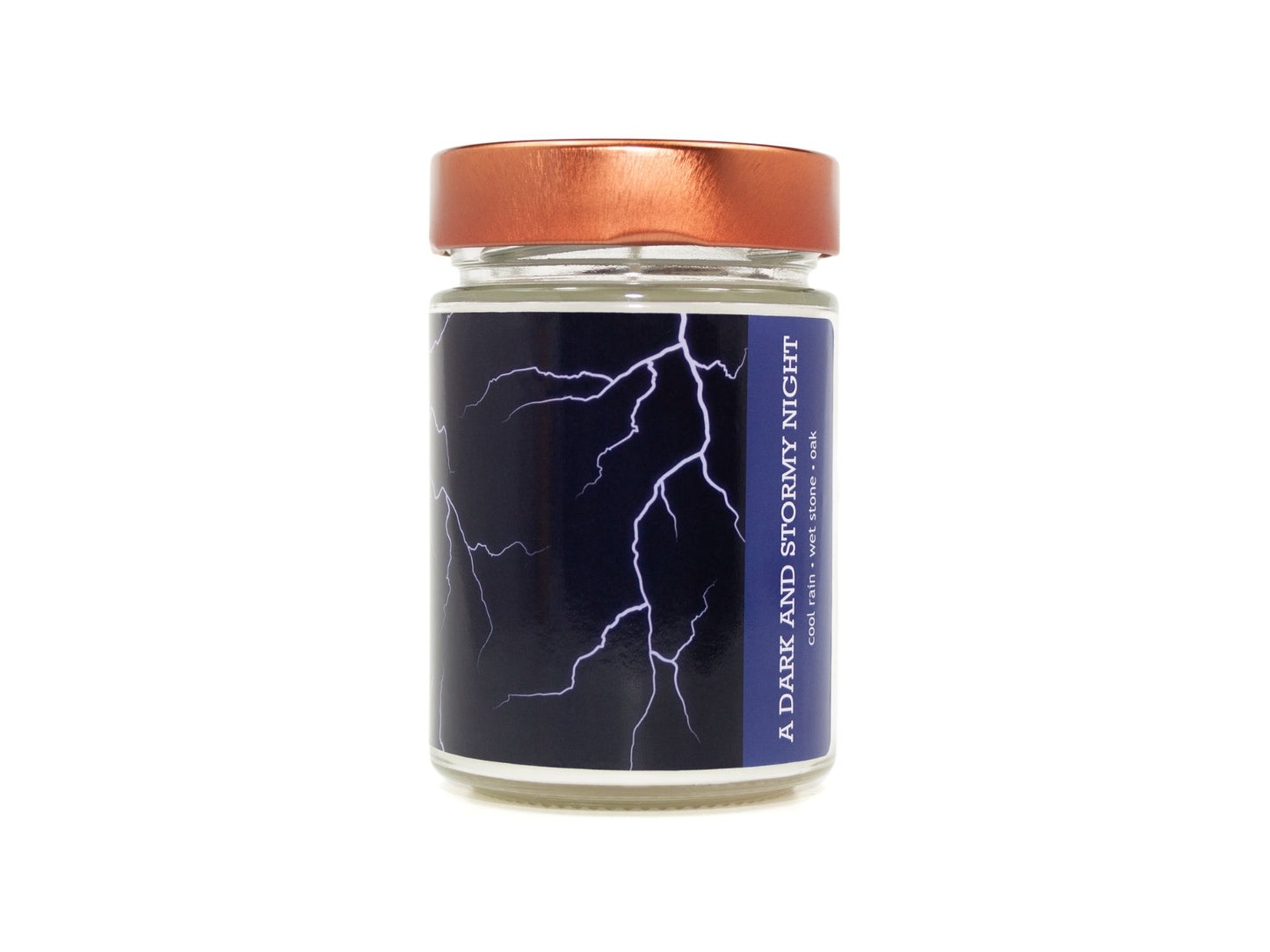 Onset & Rime rain scented candle called "A Dark and Stormy Night" in a 10 oz glass jar with copper lid. The label is dark blue with white lightning bolts. The text on the label is "A Dark and Stormy Night - Cool Rain, Wet Stone, Oak".
