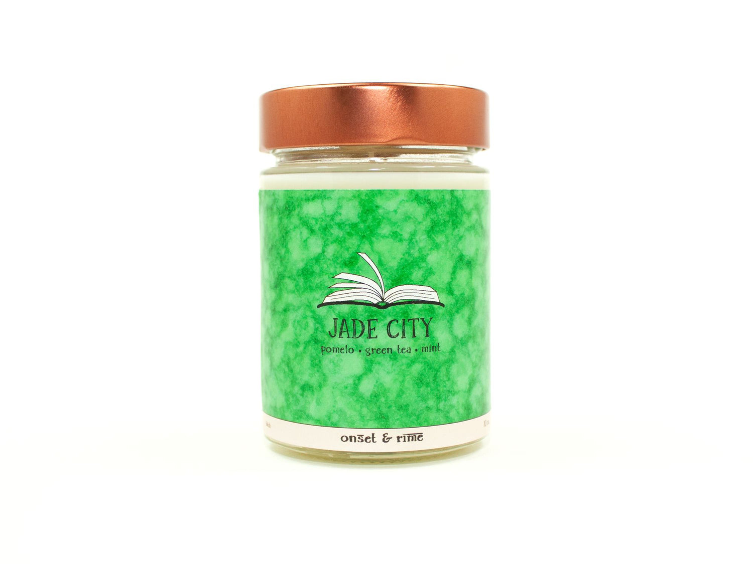 Onset & Rime pomelo, green tea and mint scented candle called "Jade City" in a 10 oz glass jar with copper lid. The label is cool green with a lighter green mottling. The text on the label is "Jade City - Pomelo, Green Tea, Mint".