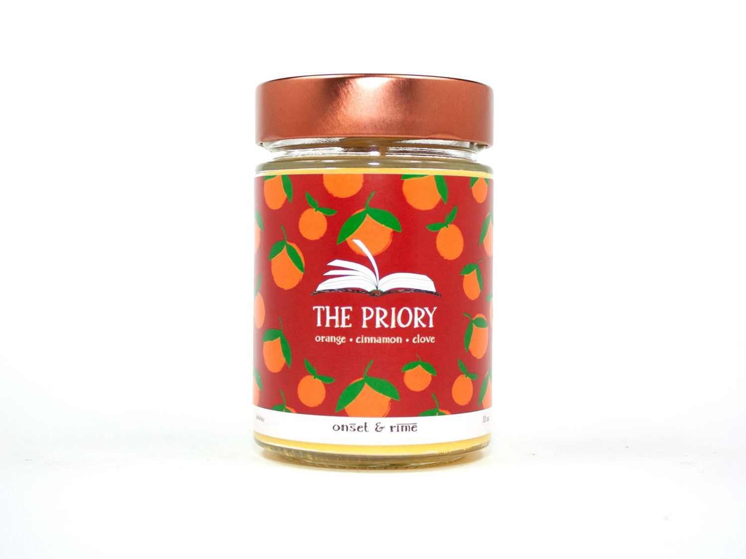 Onset & Rime spiced orange scented candle called "The Priory" in a 10 oz glass jar with copper lid. The label is red with a pattern of oranges. The text on the label is "The Priory - Orange, Cinnamon, Clove".